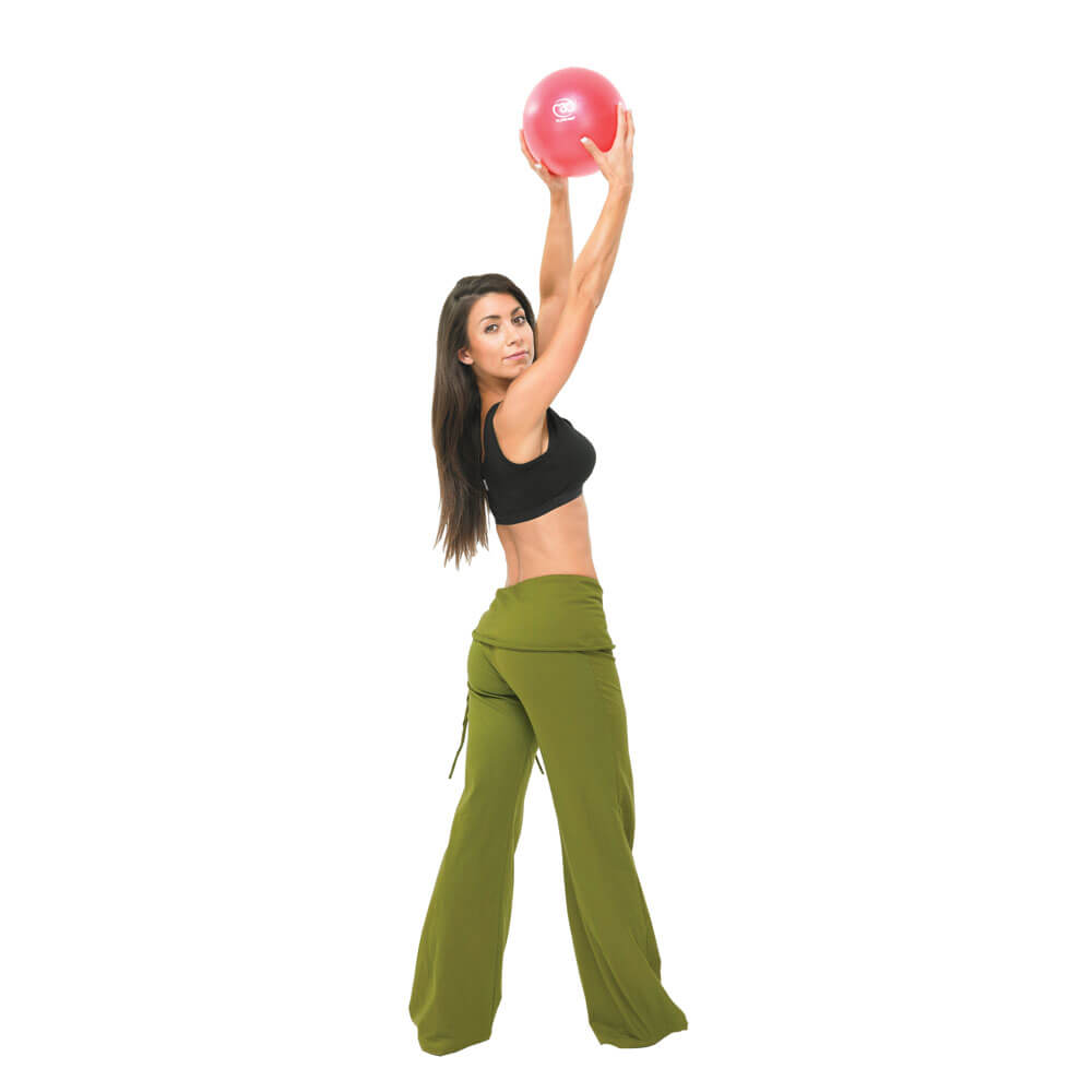 Woman holding red Fitness Mad 9 Inch Exer-Soft Ball in the air with both hands 