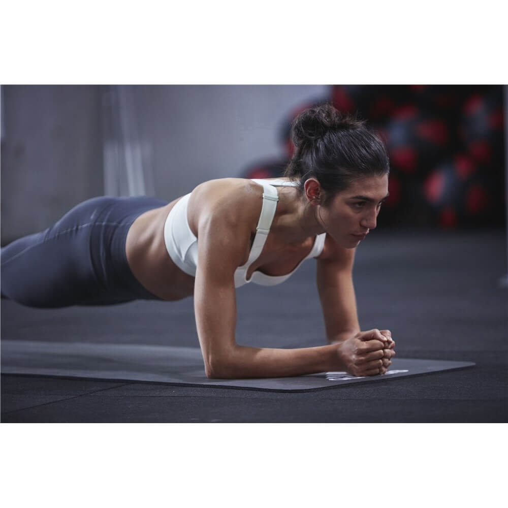 Woman performing a plank on an Adidas 7mm Training Mat - Black