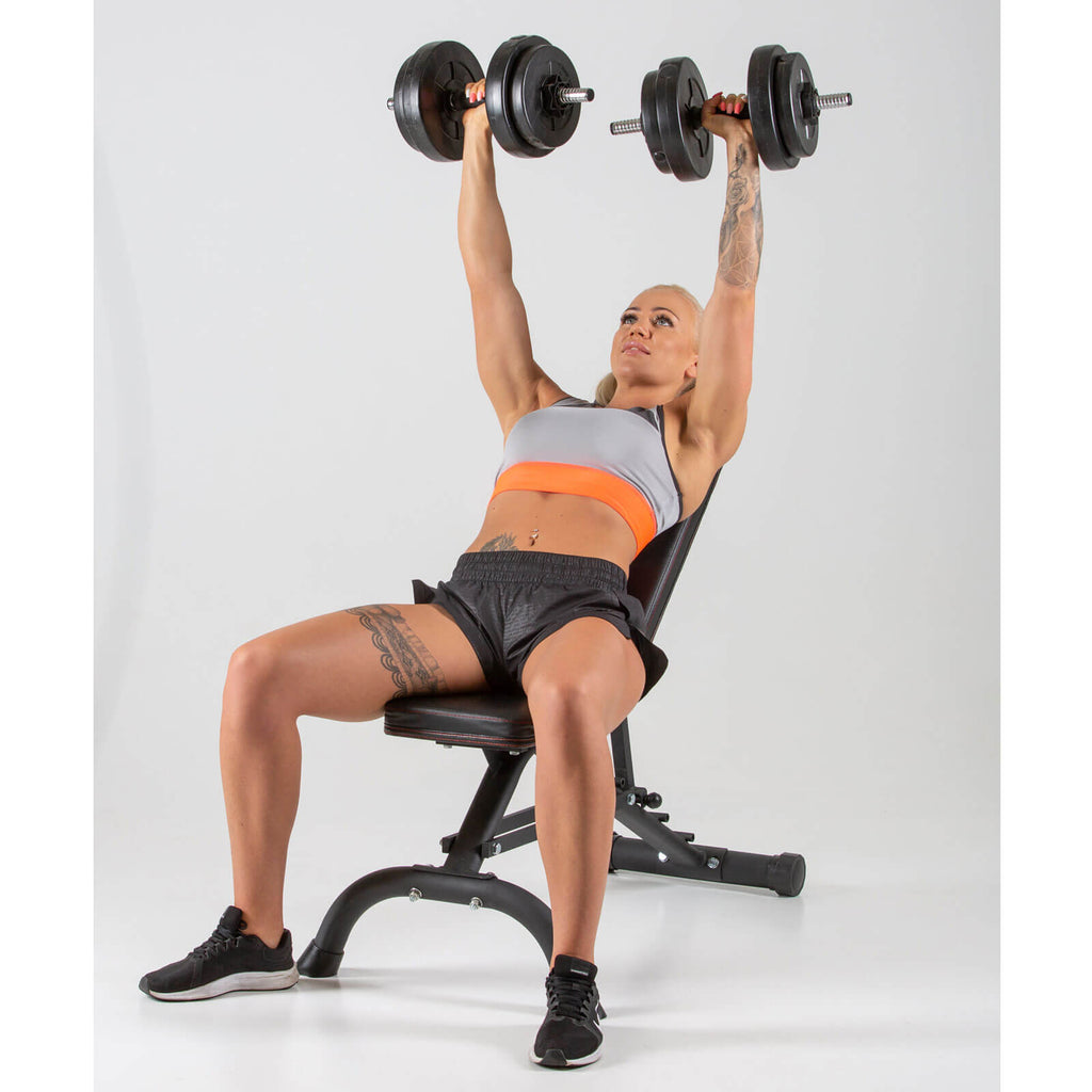 Woman performing dumbbell presses on a HXGN Ultimate Weight Bench Incline position