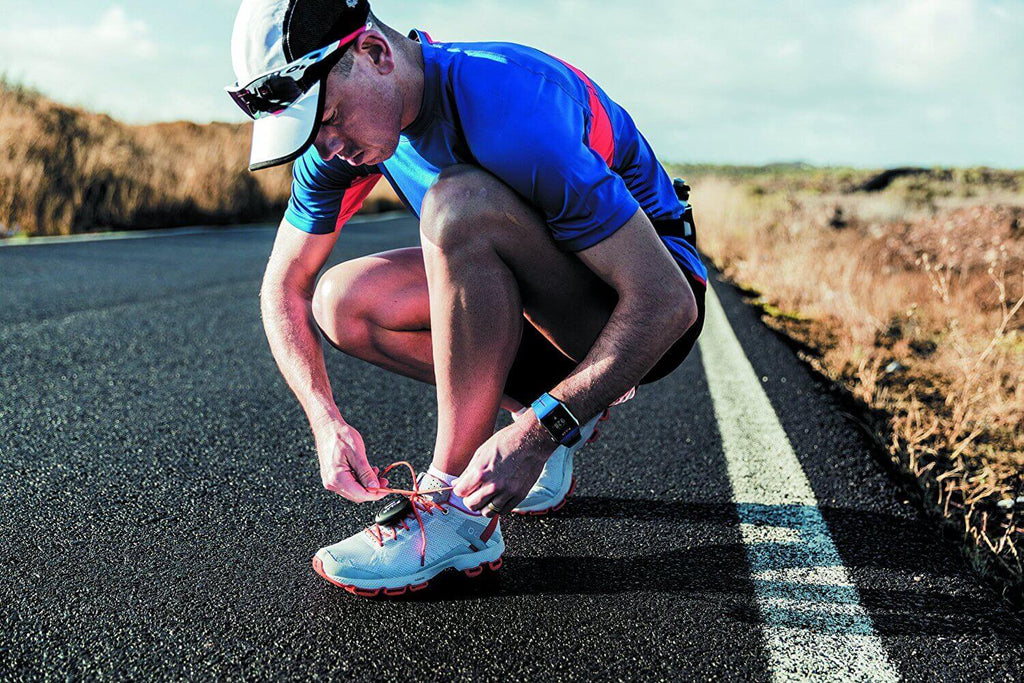 Runner tying his lace whilst wearing Polar Stride Sensor Bluetooth Smart