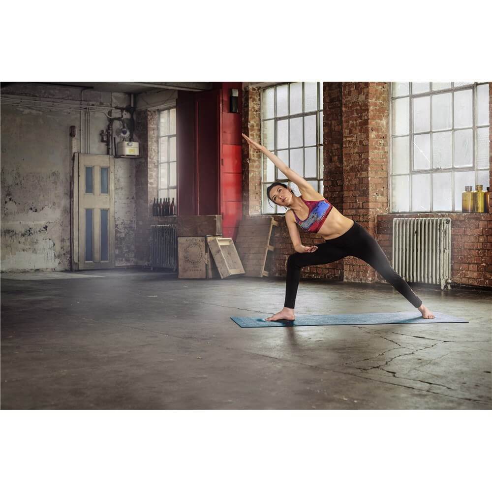 Reebok Double Sided 4mm Yoga Mat - Green Stripes - Woman performing a stretching workout