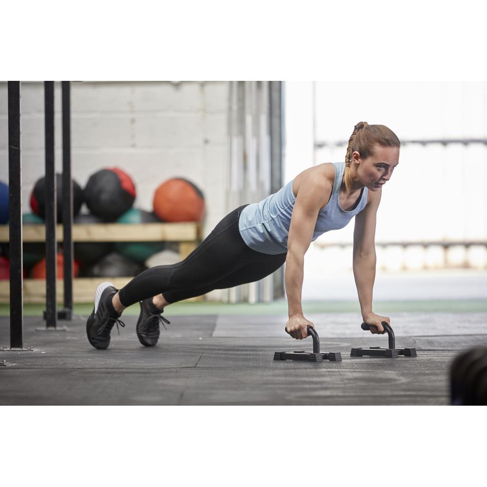 Woman performing push-ups in a gym setting