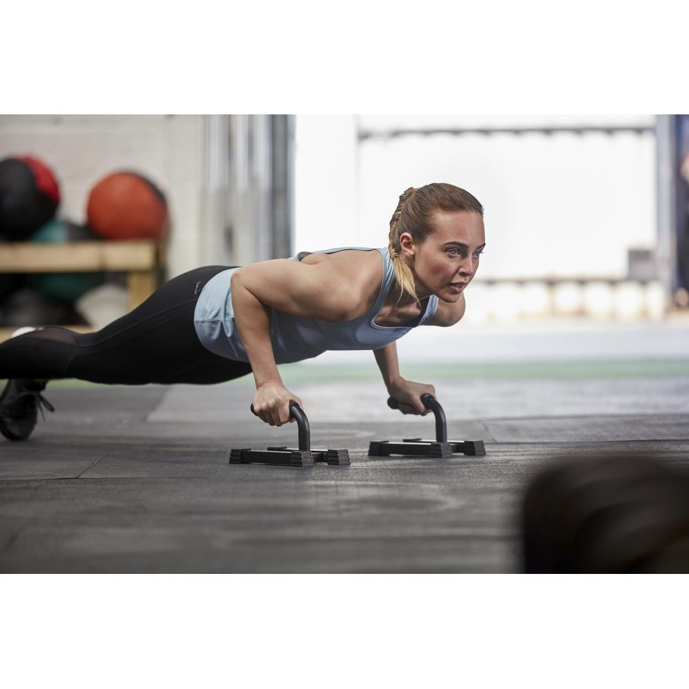 Woman performing push-ups with the Adidas Premium Push Up Bars