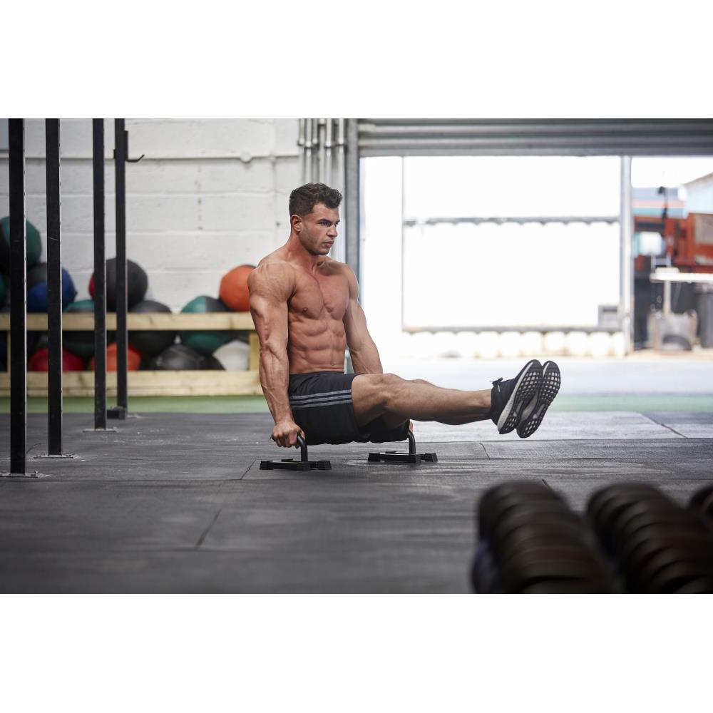 Man exercising using the Adidas Premium Push Up Bars in the gym