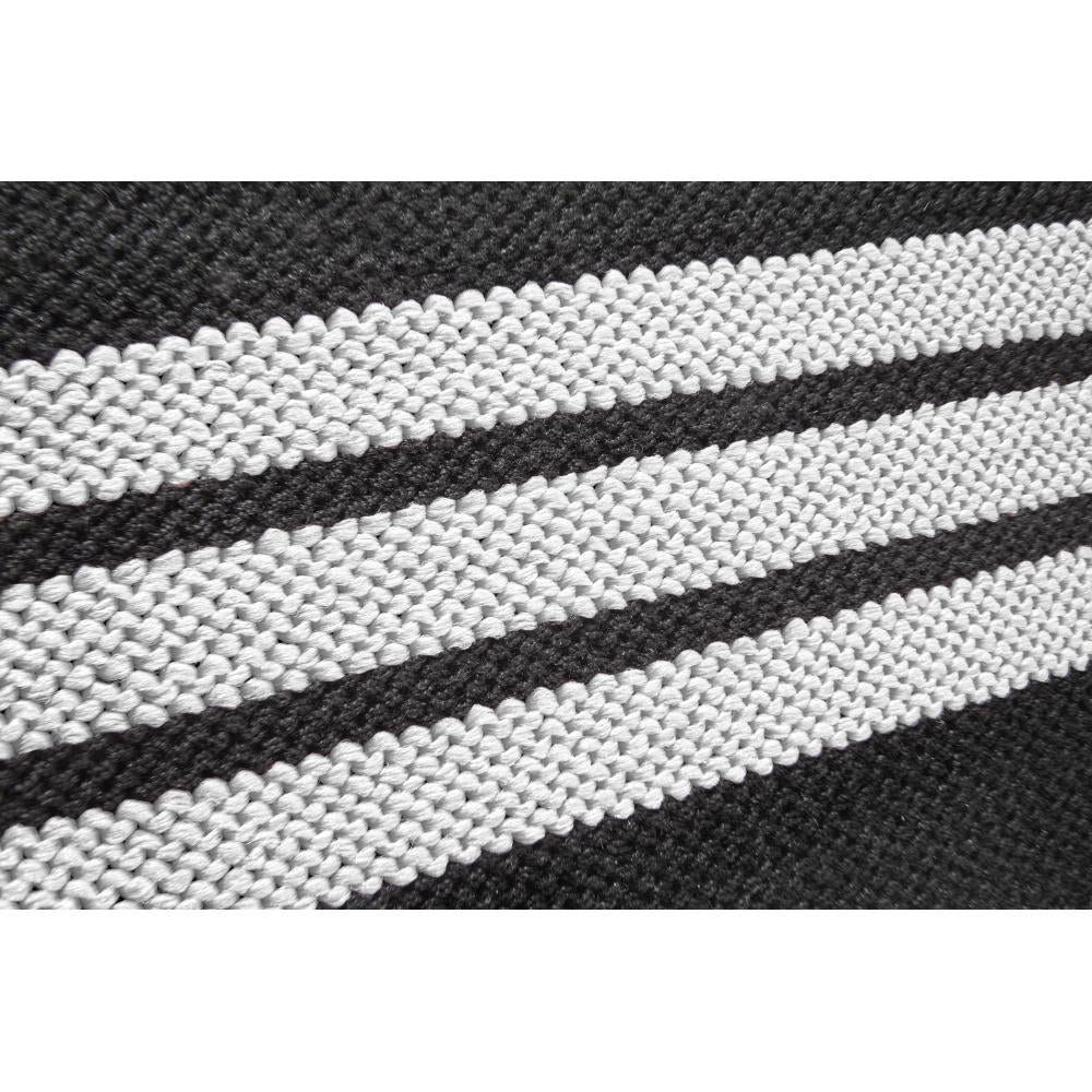 Close-up of black and white striped fabric pattern from the adidas wrist wraps