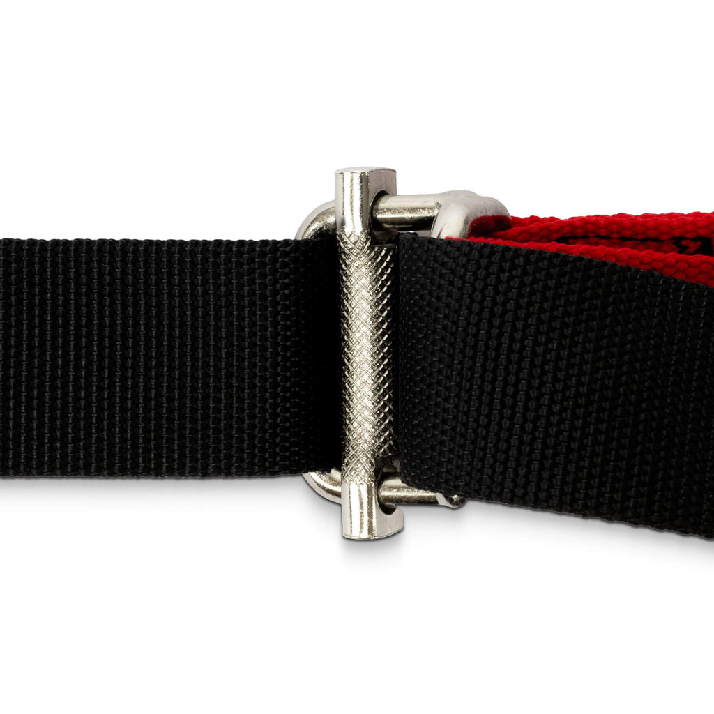 Close-up of a black and red Fitness Mad Pro Bodyweight Suspension Trainer belt with a silver buckle on a white background