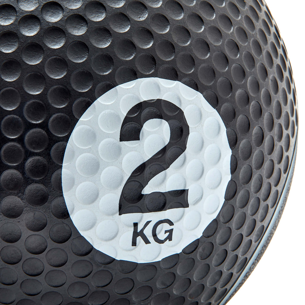 Black weight ball with a white label displaying '2 KG' on a white background