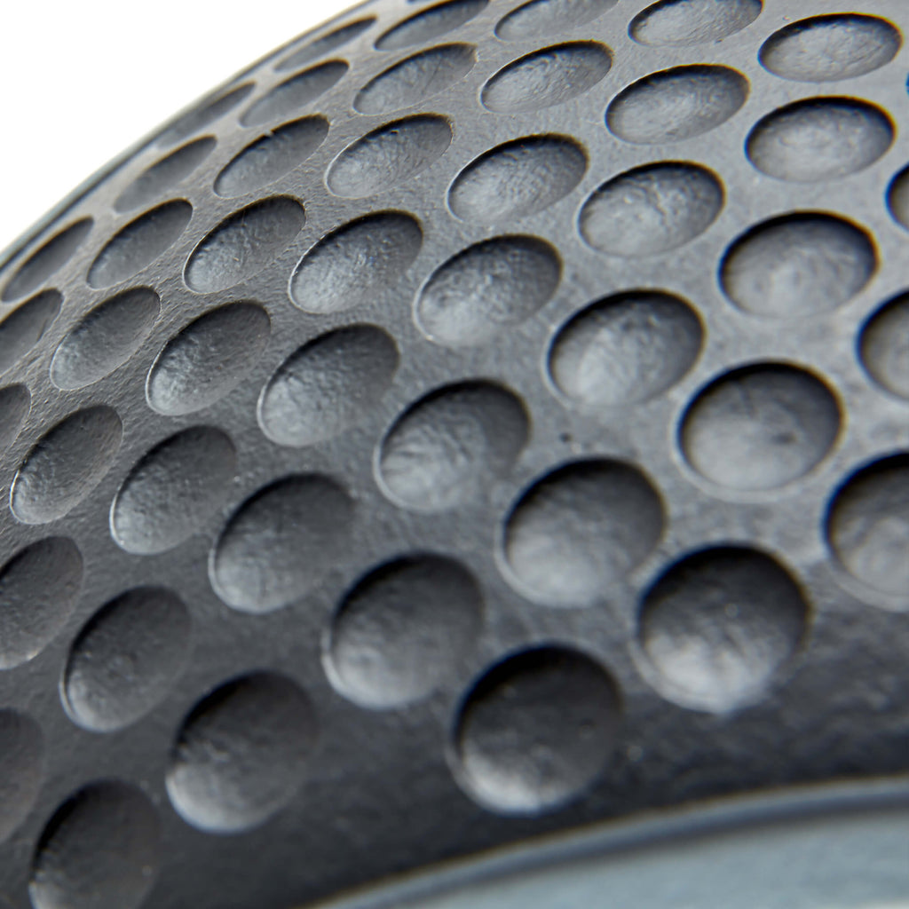 Close-up of a textured black surface with circular patterns on a Reebok 3kg Medicine Ball
