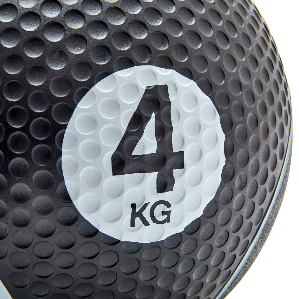 Black medicine ball with '4 KG' marking on a white background