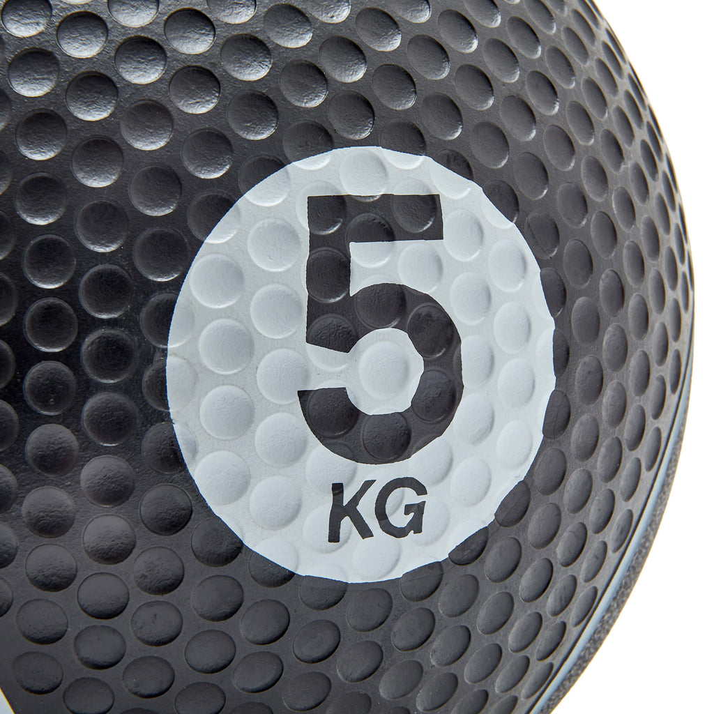 Black medicine ball with '5 KG' marking on a white background