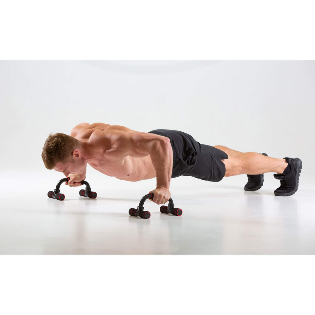 Man performing push ups using HXGN Push Up Parallels