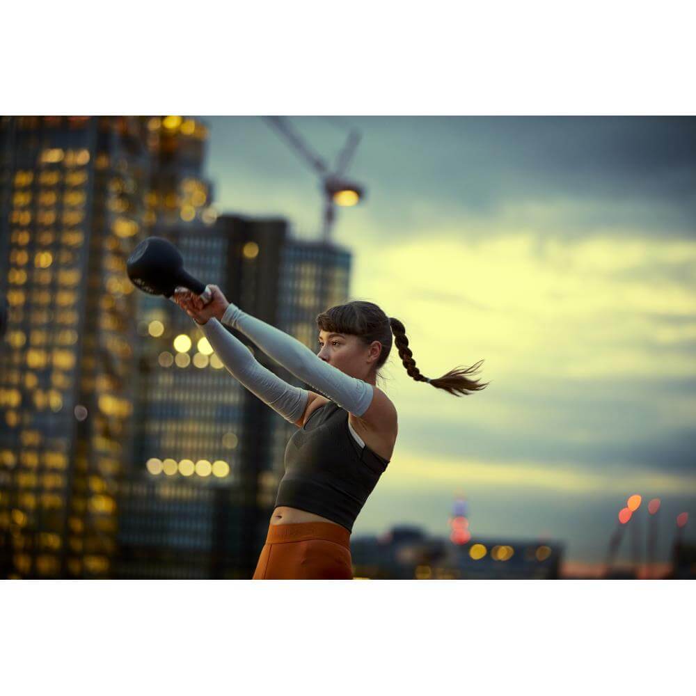 Woman swinging an adidas 12kg kettlebell