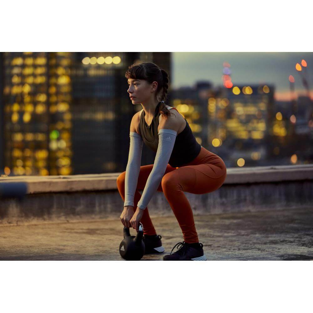 Woman squatting with an adidas 12kg kettlebell