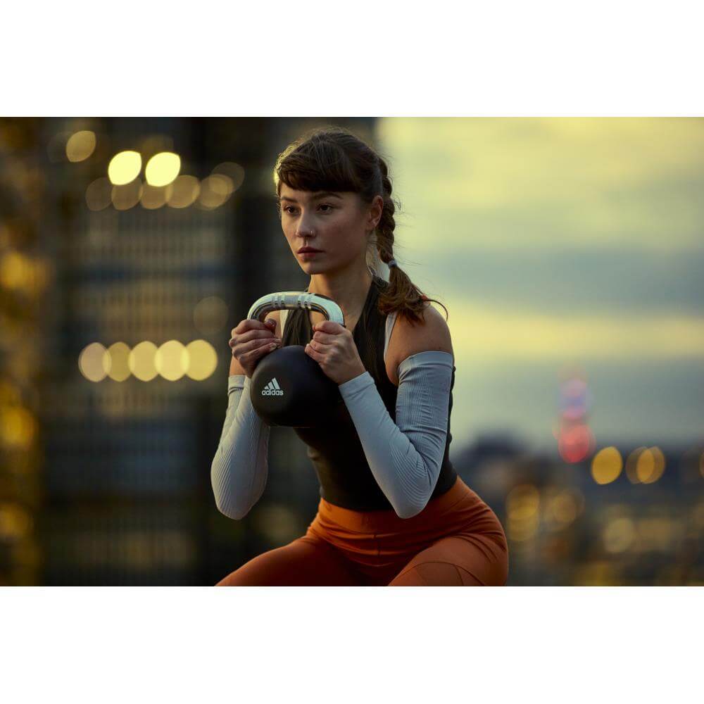 Woman exercising with an adidas 12kg kettlebell