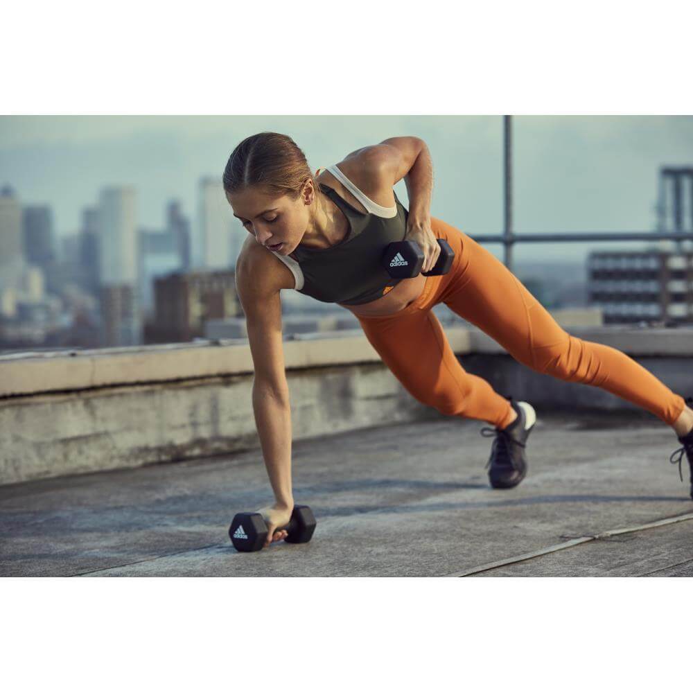 Woman holding adidas 3kg Dumbbells -performing a gym workout