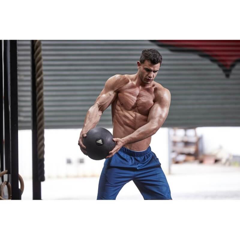 Man exercising in the gym using an adidas 5kg Slam Ball - Gym Workout