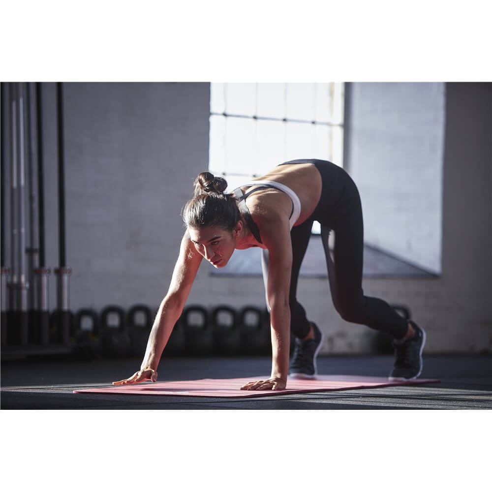 Woman exercising on an Adidas 7mm Training Mat - Red