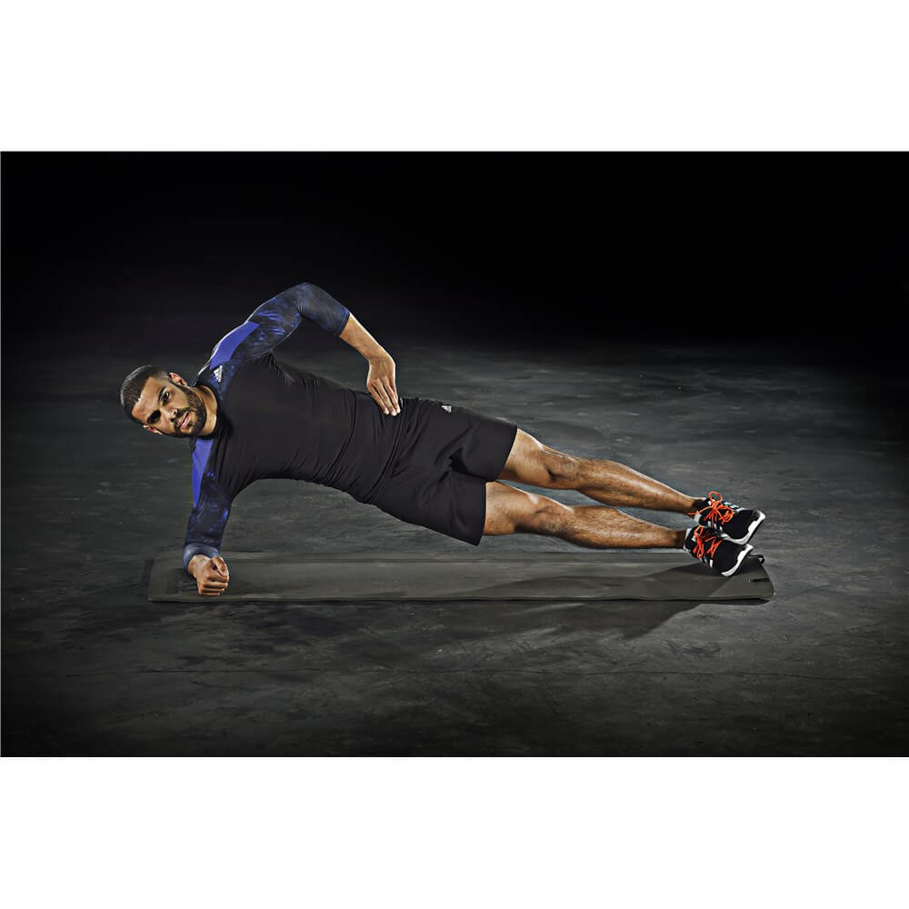 Man performing side plank on an adidas Elite Training Mat 