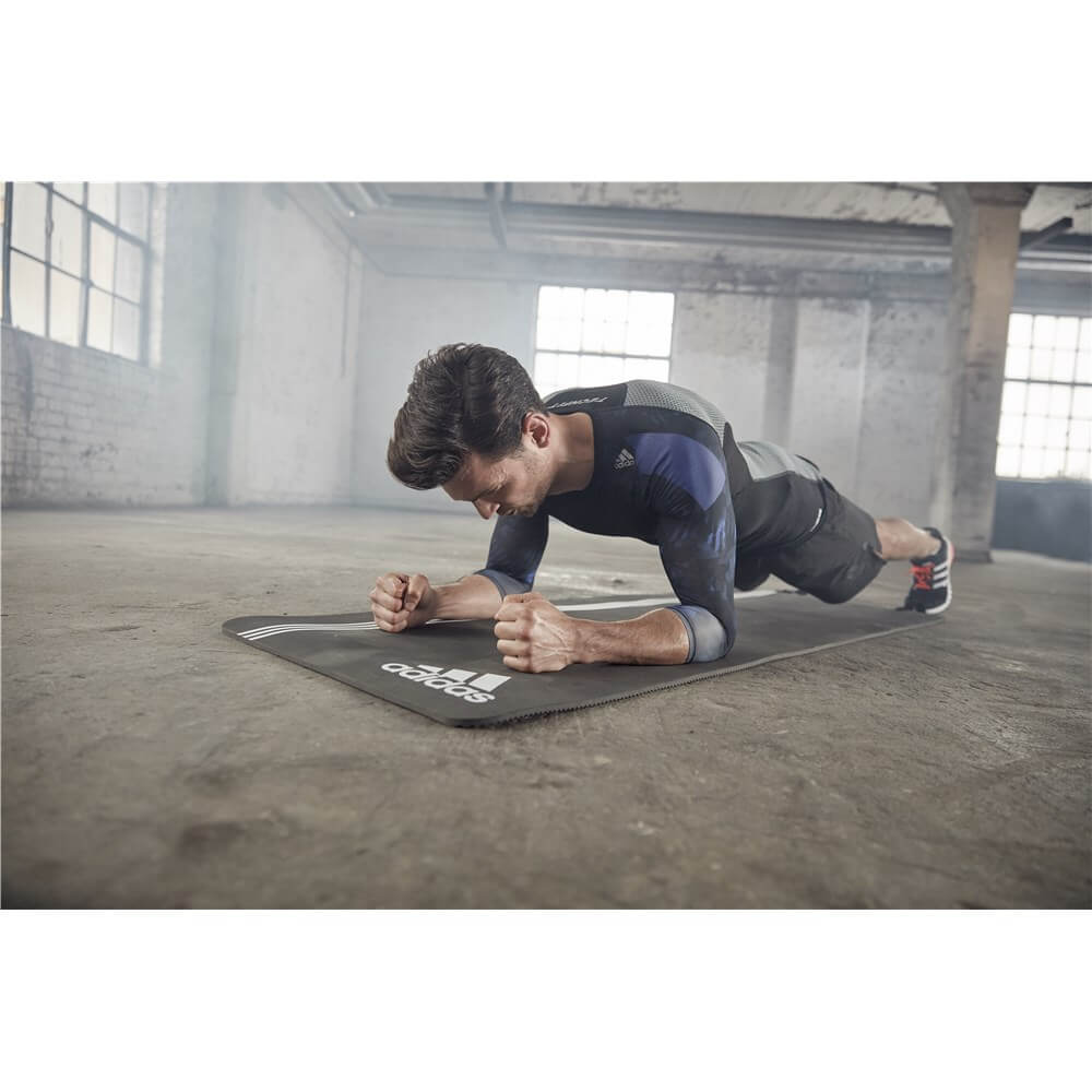 Man performing a plank on an adidas Elite Training Mat 