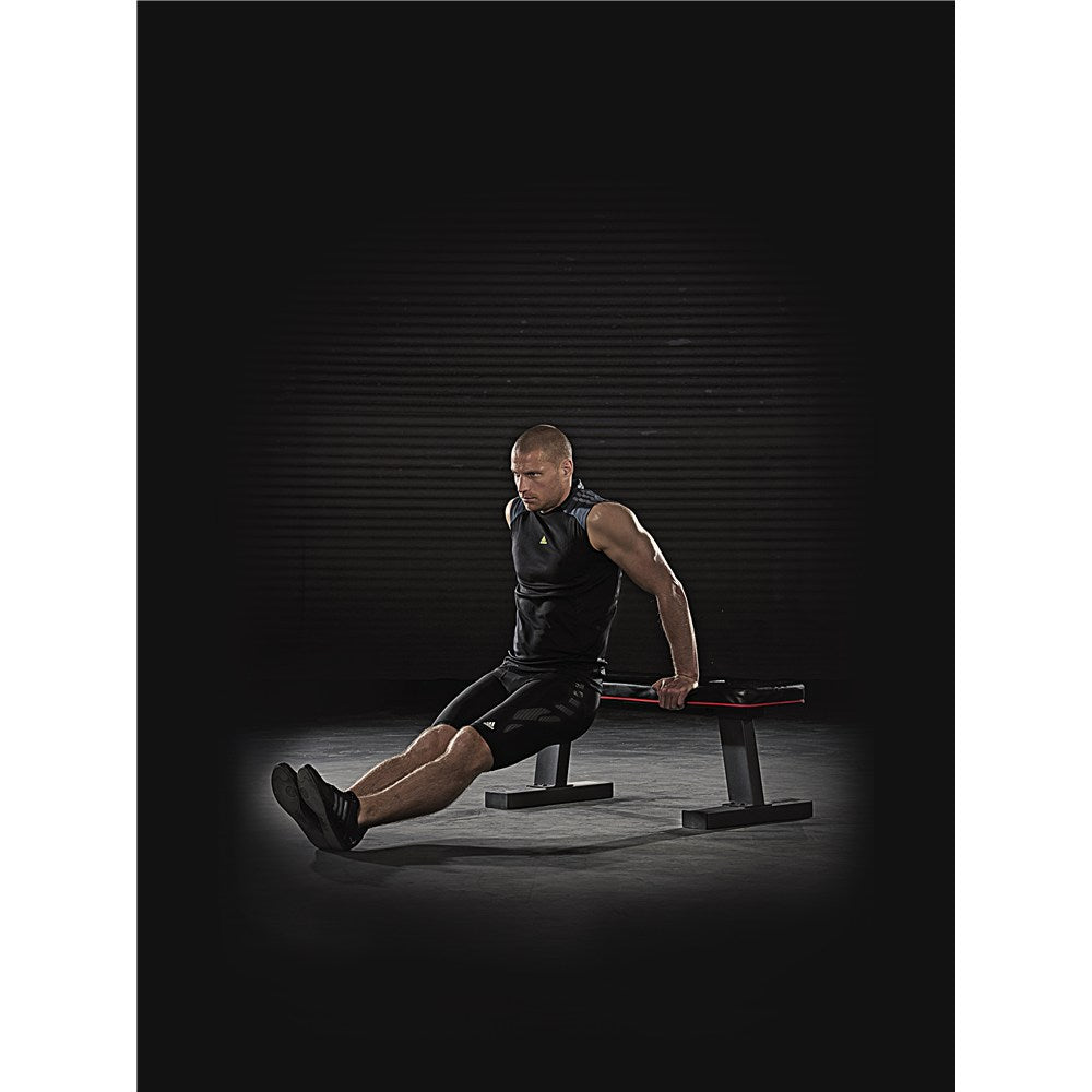 Man exercising using an adidas Flat Training Weight Bench