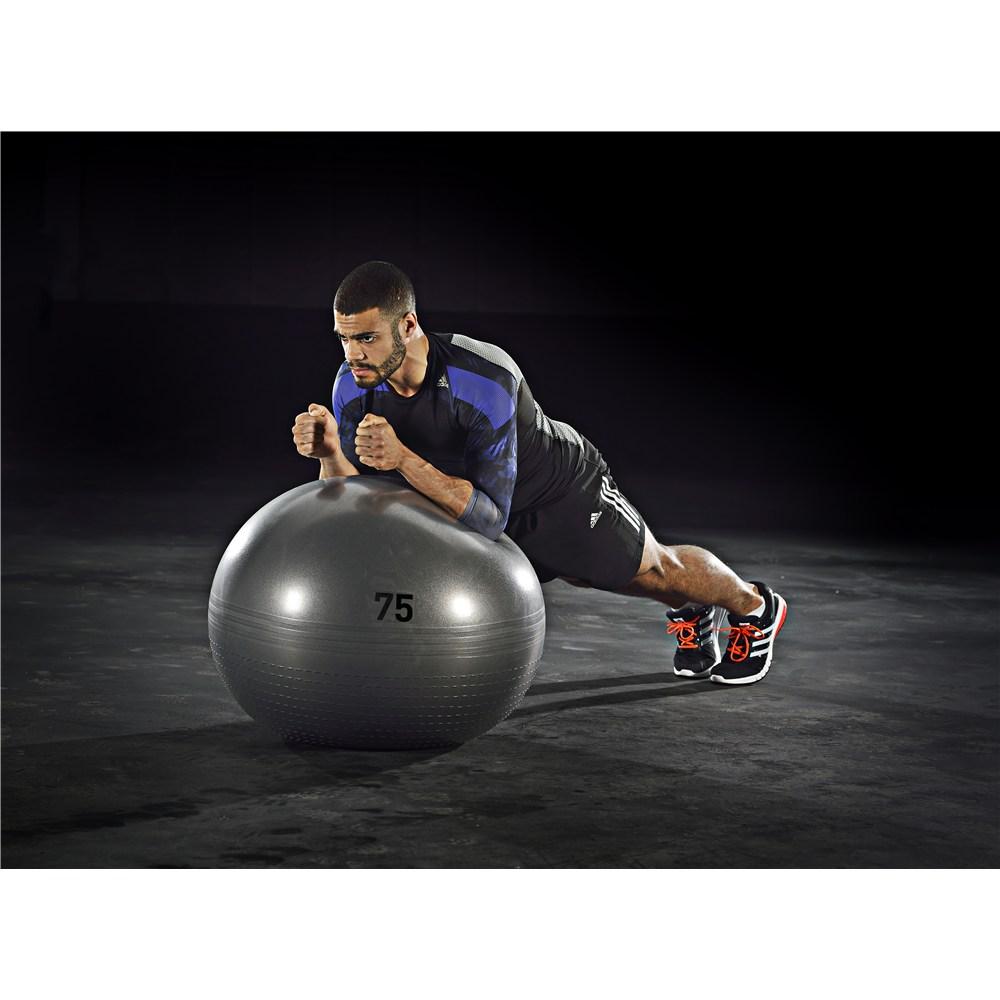Man exercising using an adidas Exercise Ball - 75cm Grey