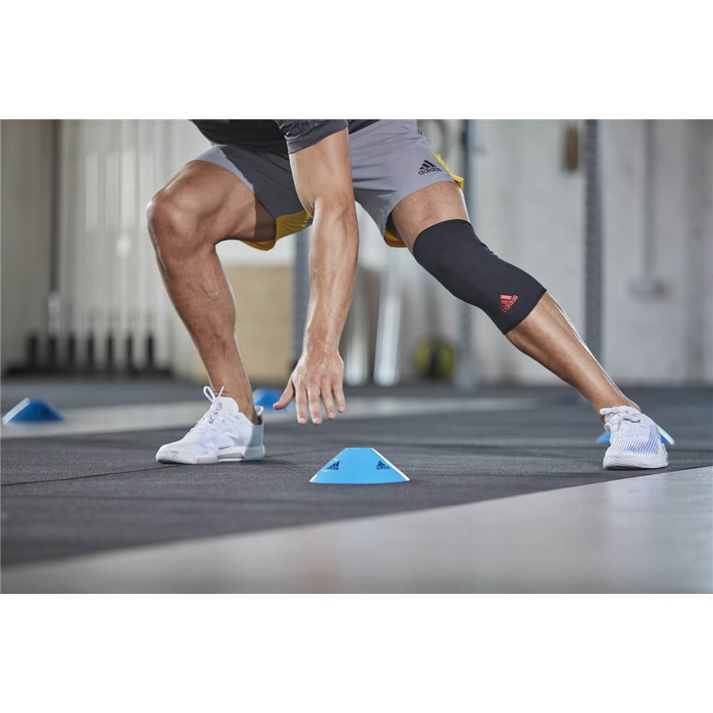 Man working out whilst wearing an Adidas Knee Support 