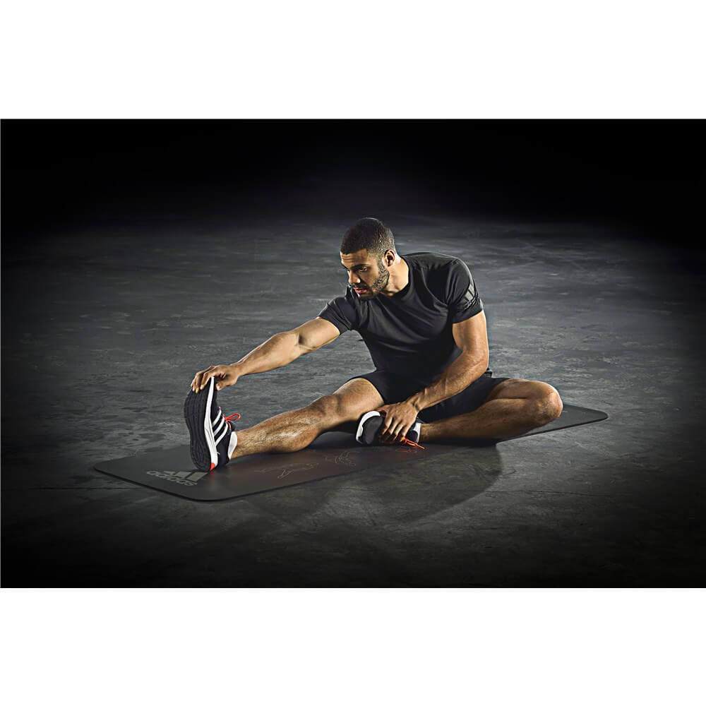 Man performing stretches on an adidas Stretch Mat 