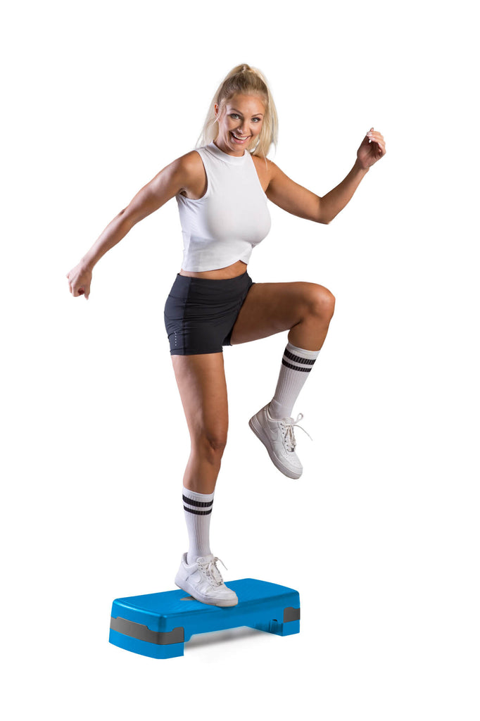 Woman performing step-ups on an azure Adjustable Cardio Shape Step Platform