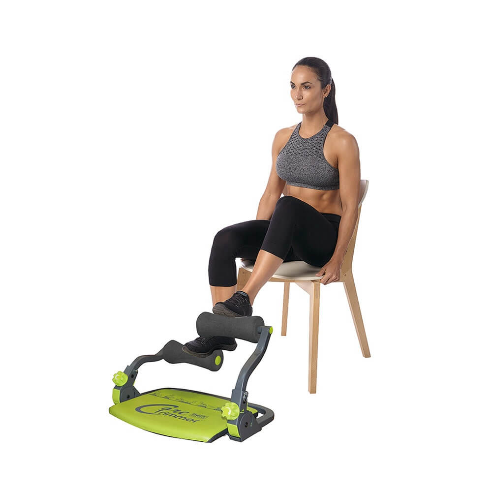 Woman sitting on a chair performing leg exercises with a body-sculpture-core-trimmer