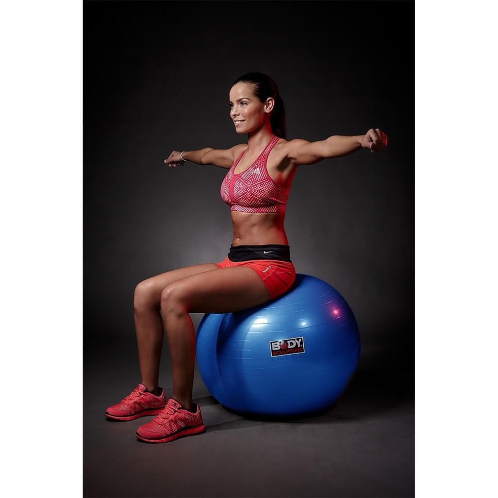 woman sitting on a body-sculpture-gym-ball-65cm performing exercises