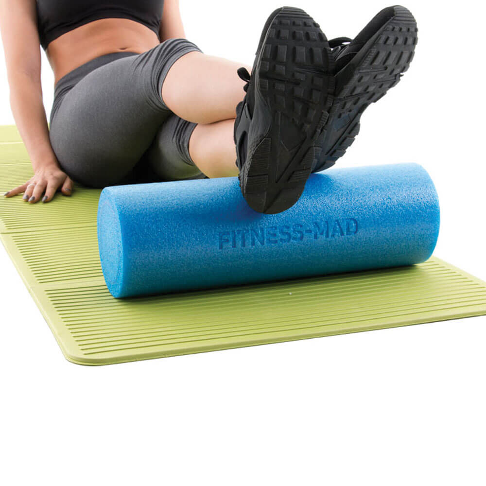 Woman using a Fitness Mad 45cm Foam Roller on her legs