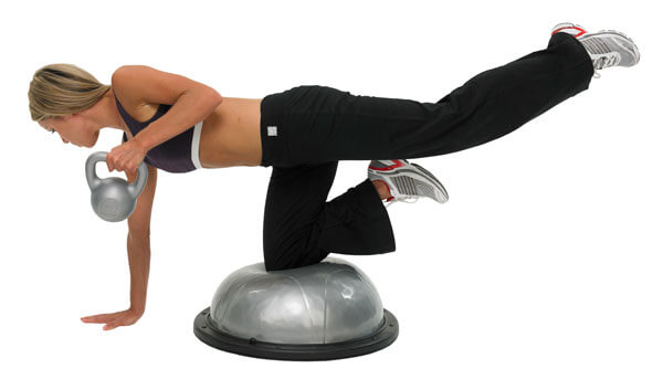 Woman exercising whilst holding a Fitness Mad 5kg PVC Kettlebell