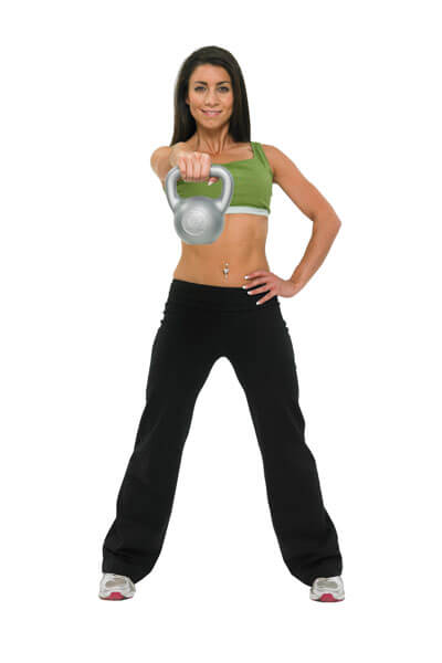 Woman exercising with a Fitness Mad 5kg PVC Kettlebell