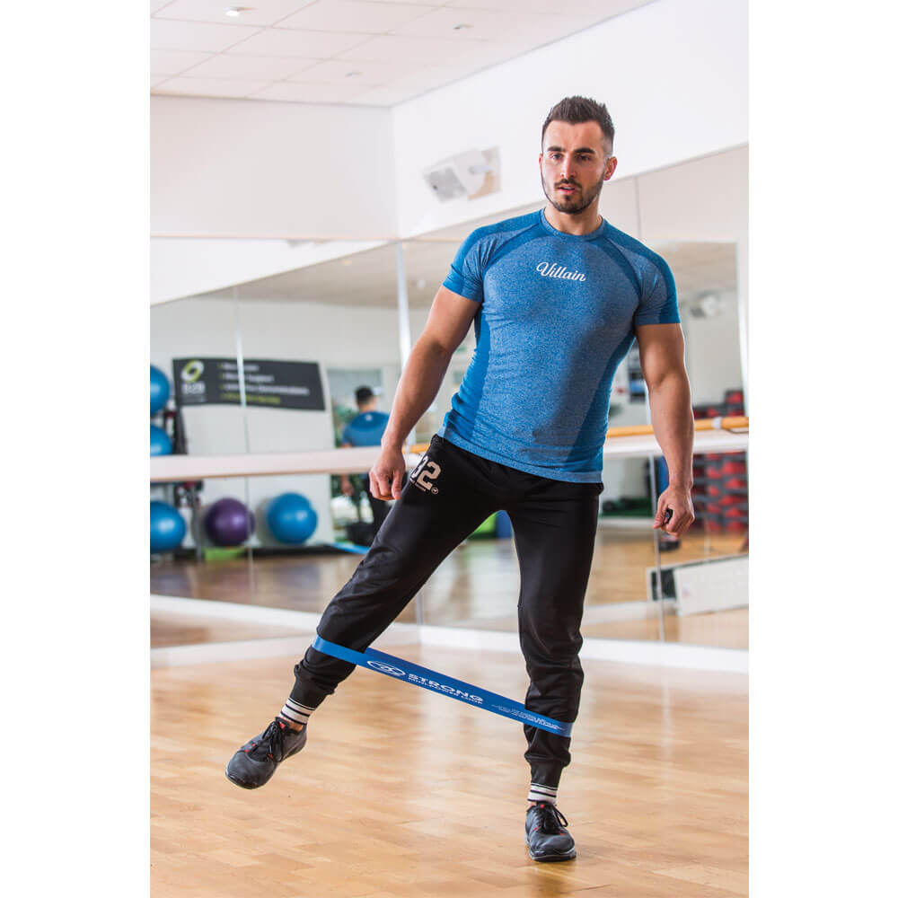 Man exercising with Fitness Mad Mini Loop Strong around his calves