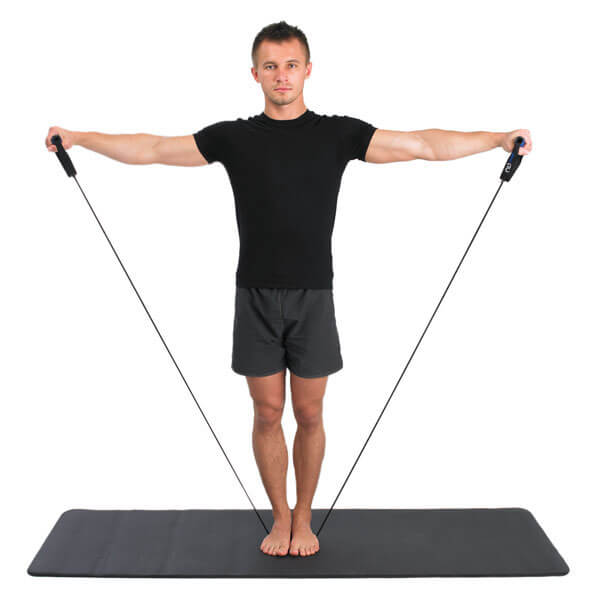 Man standing on an exercise mat exercising with a Fitness Mad resistance tube