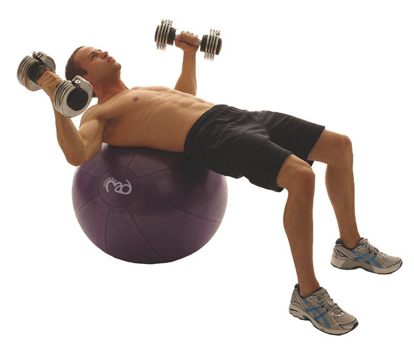 Man performing chest press exercises with dumbbells whilst lying on a Fitness Mad Studio Pro 500Kg Gym Ball  - 65cm