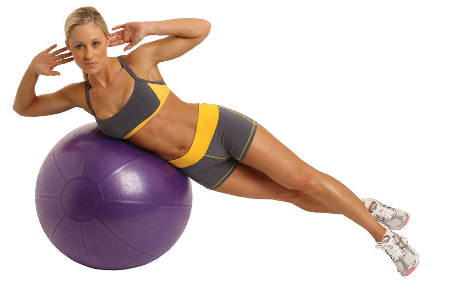 Woman exercising on a Fitness Mad Studio Pro 500Kg Gym Ball  - 75cm