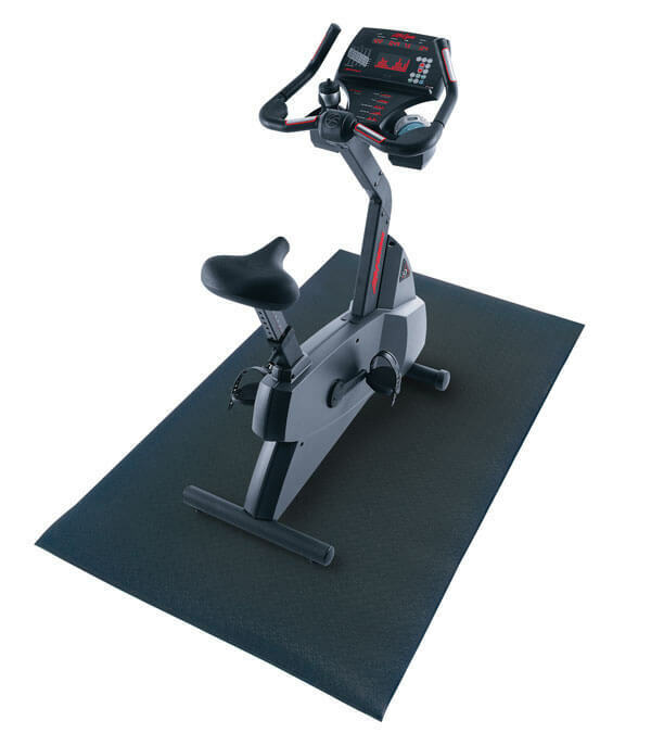 Exercise bike resting on a Fitness Mad Treadmill Mat
