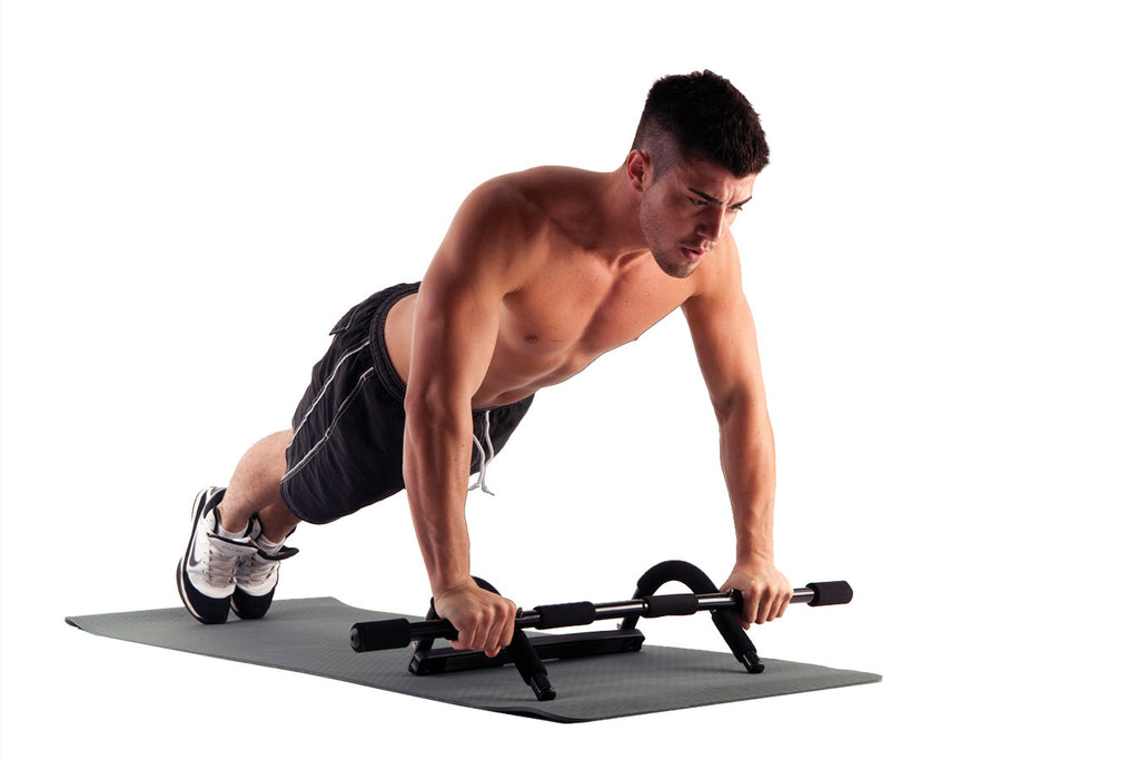 Man performing push ups on a mat using a Fitness Mad Universal Training Pull Up Bar