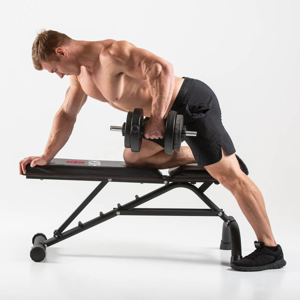 Man performing dumbbell rows on a HXGN Ultimate Weight Bench 