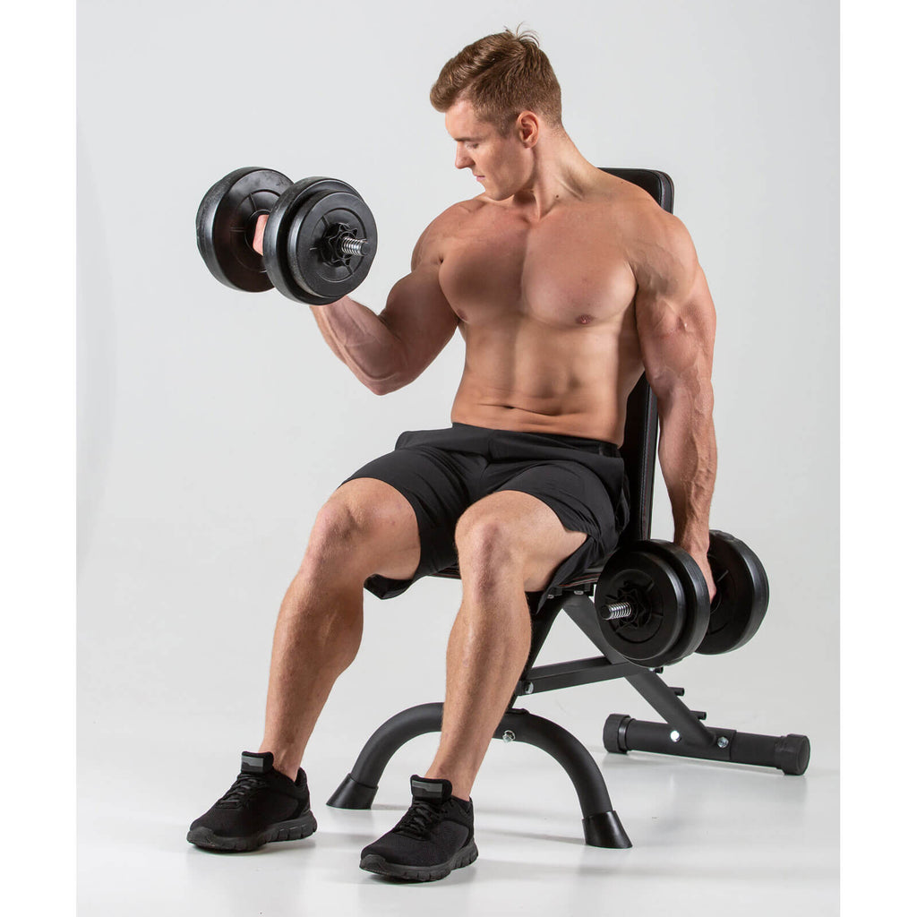 Man performing bicep curls sitting on a HXGN Ultimate Weight Bench