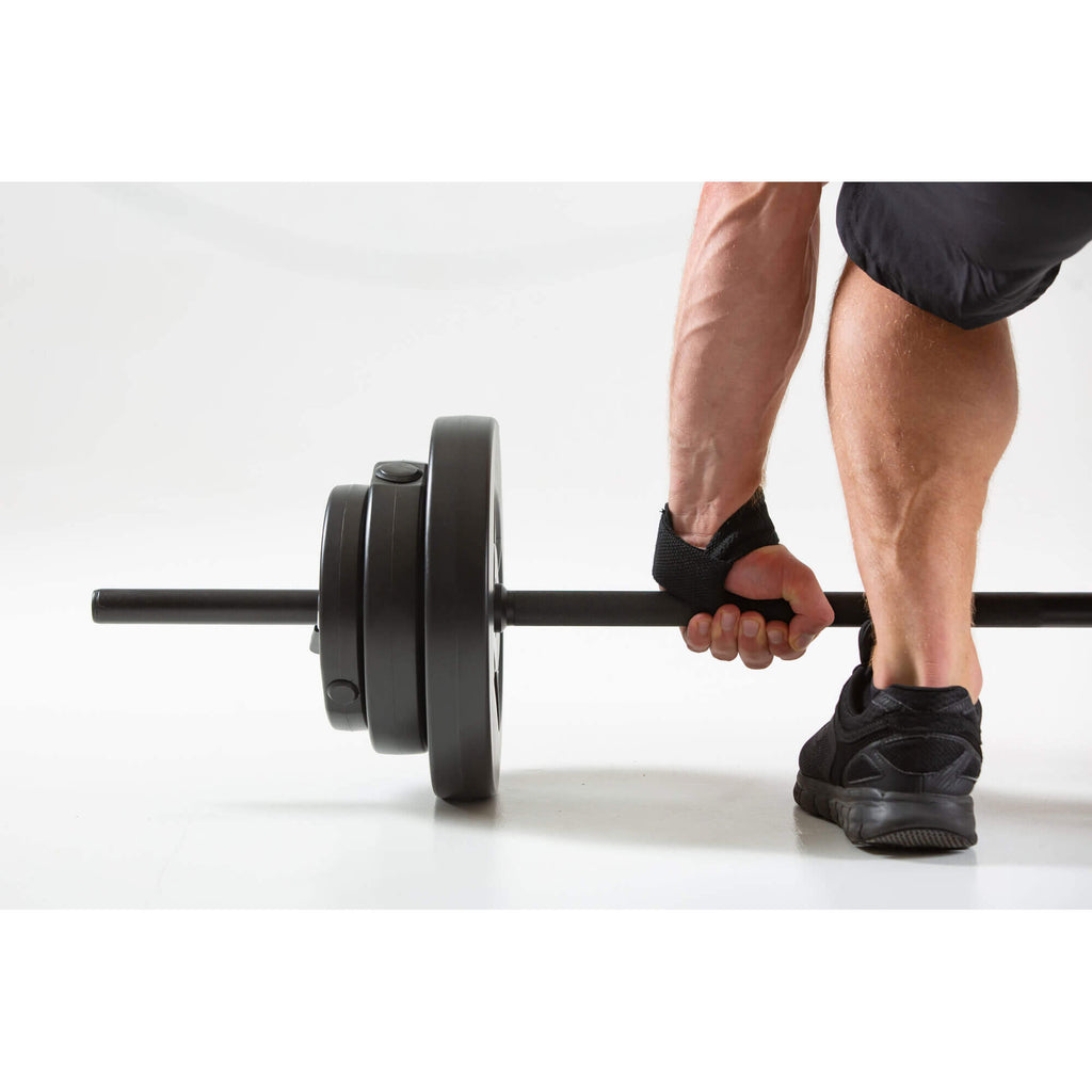 Man performing a gym workout wearing HXGN Weight Lifting Straps 