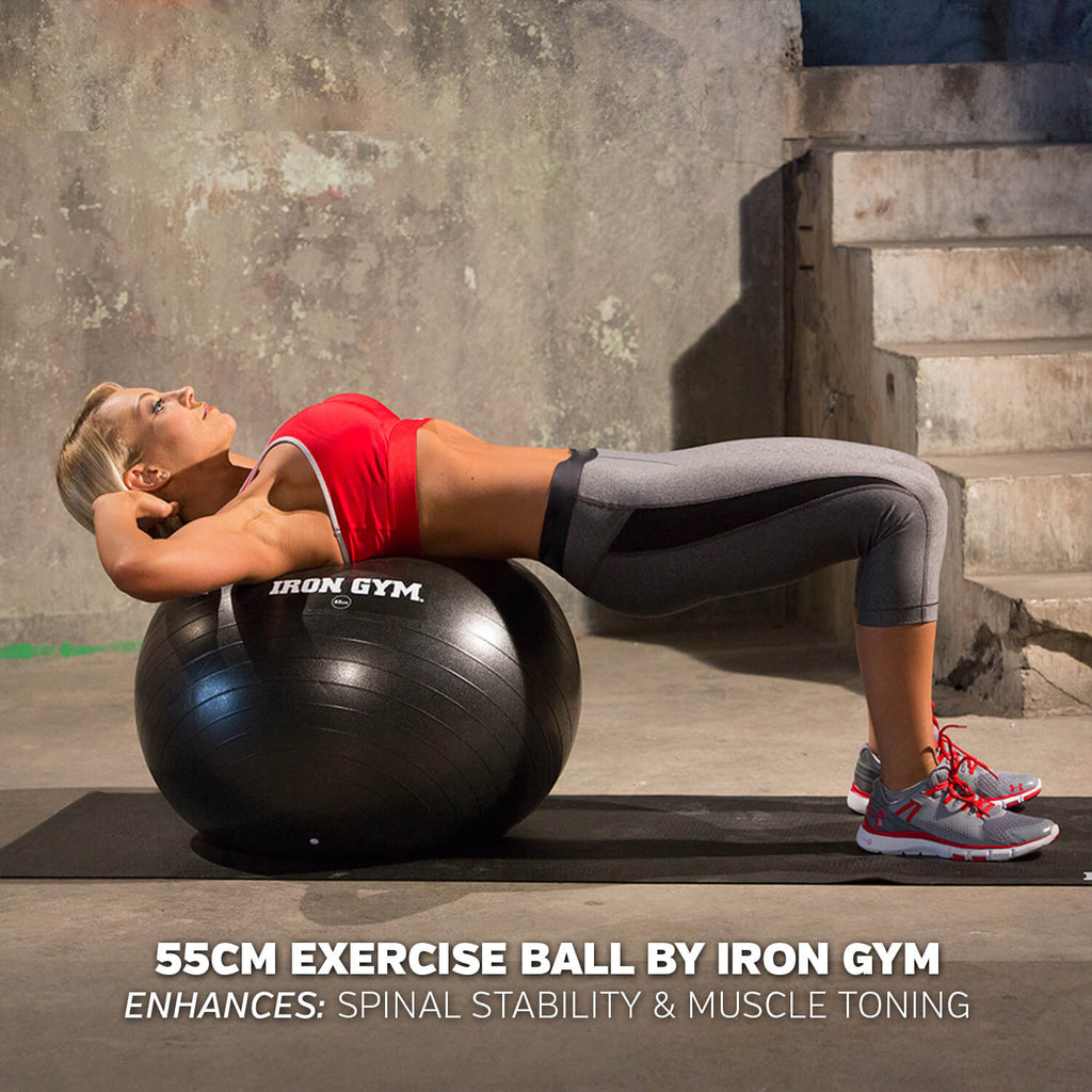 Woman exercising on an Iron Gym Essential Exercise Ball - 55cm