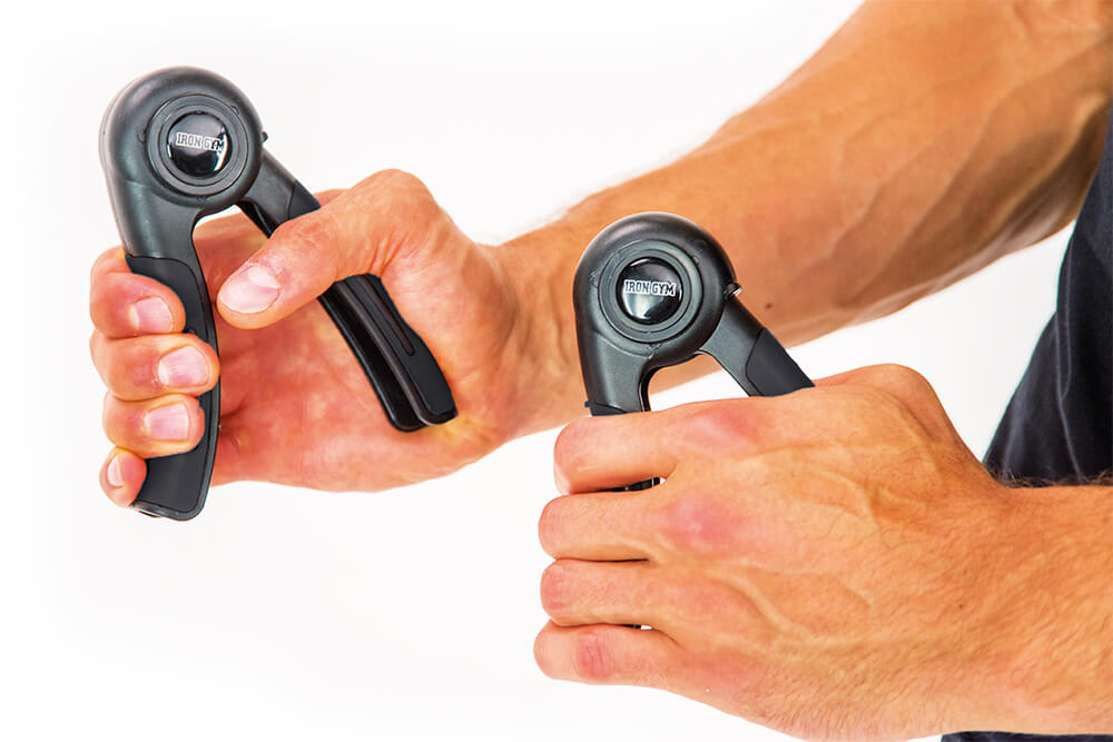 Man gripping Iron Gym Hand Grips Pair