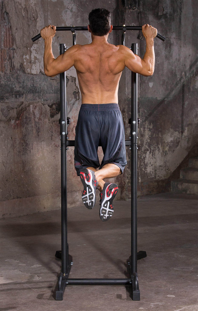 Man performing pull ups on an Iron Gym Power Tower