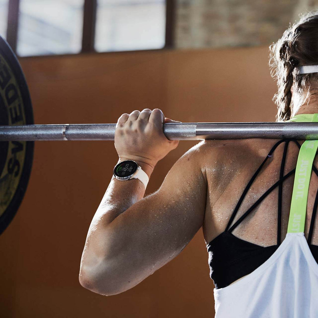 Woman performing squats whilst wearing her Polar Ignite Fitness Watch