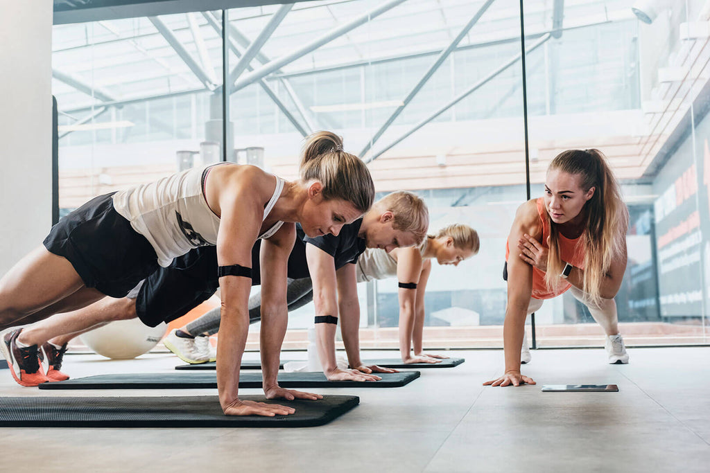 Exercise class showing attendees wearing Polar OH1 Arm Heart Rate Monitor