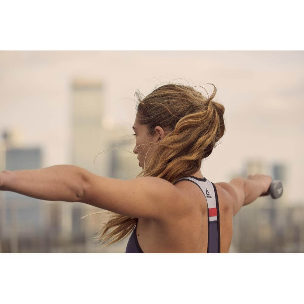 Woman exercising using Reebok 1kg Dumbbells