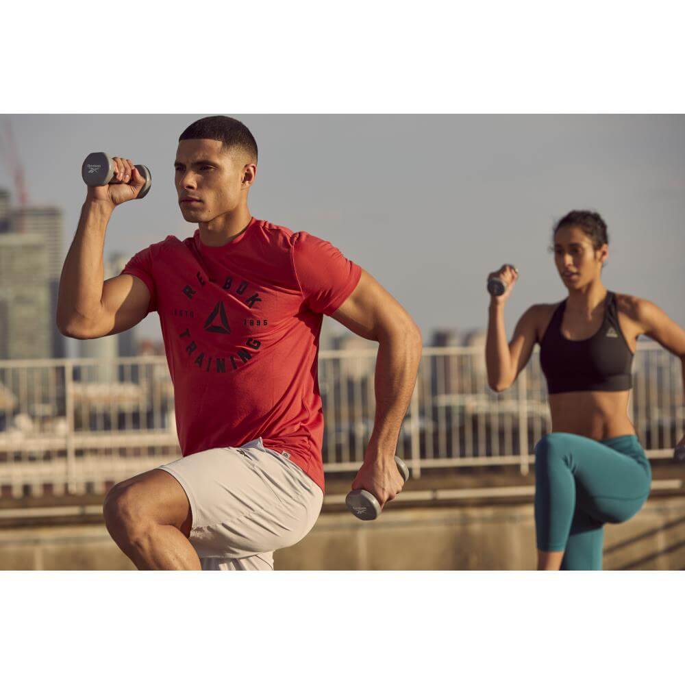 Man and woman exercising with Reebok 2kg Dumbbells