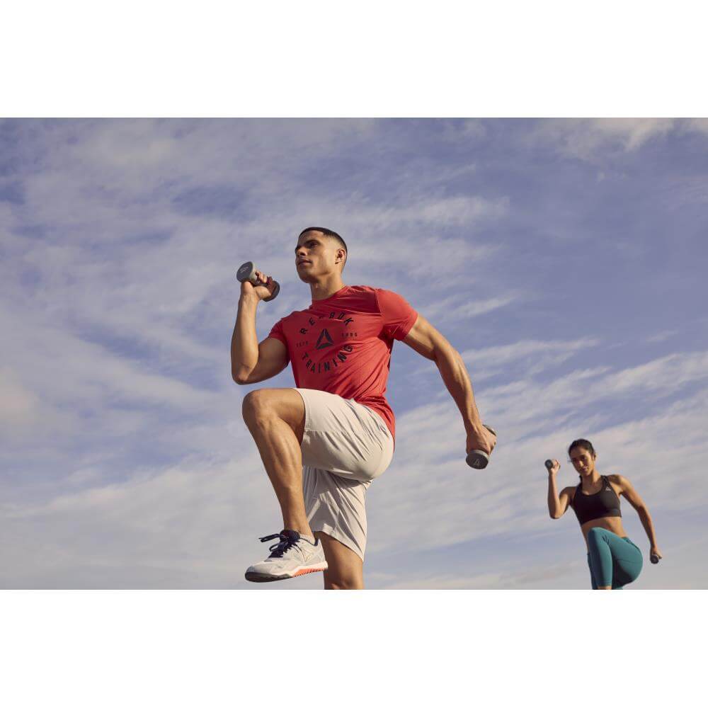Man and woman exercising with Reebok 2kg Dumbbells